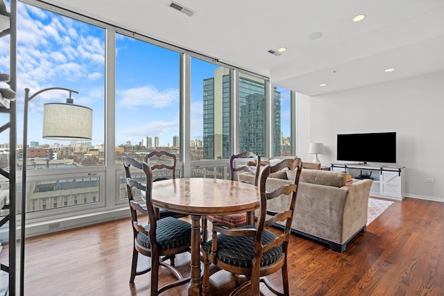 dining area featuring a wall of windows and dark hardwood / wood-style floors