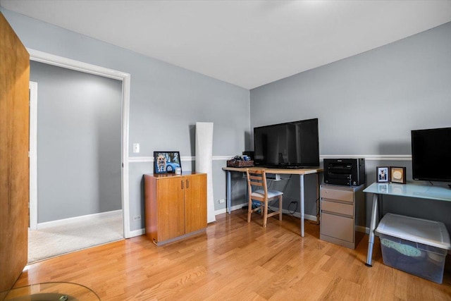 office with light wood-type flooring