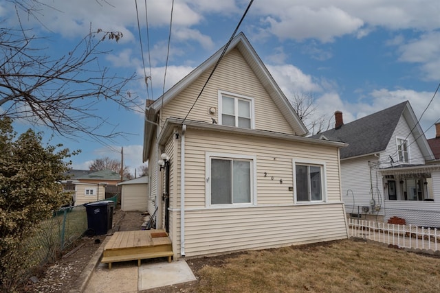 rear view of property featuring a lawn