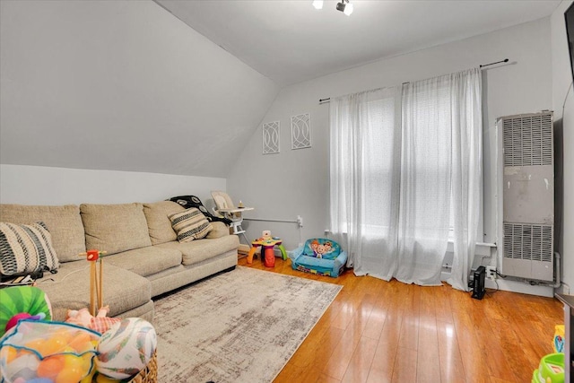 living room with wood-type flooring and vaulted ceiling