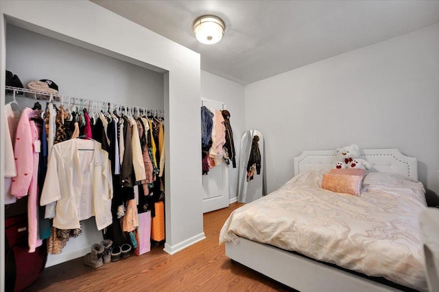 bedroom featuring hardwood / wood-style flooring and a closet