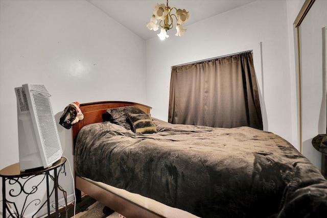 bedroom with lofted ceiling and a chandelier