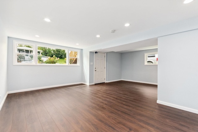 unfurnished room with dark hardwood / wood-style flooring