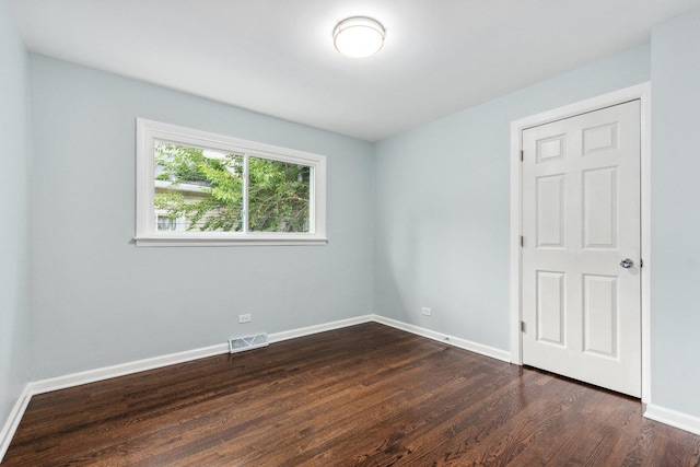 empty room featuring dark wood-type flooring