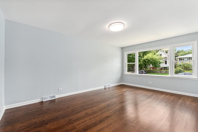 spare room featuring dark hardwood / wood-style floors