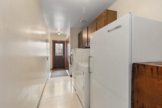 laundry area featuring cabinets and independent washer and dryer