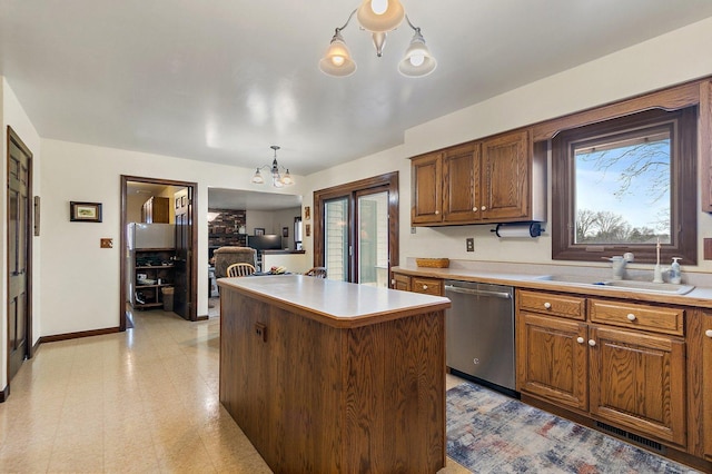 kitchen with sink, a chandelier, a center island, stainless steel dishwasher, and pendant lighting