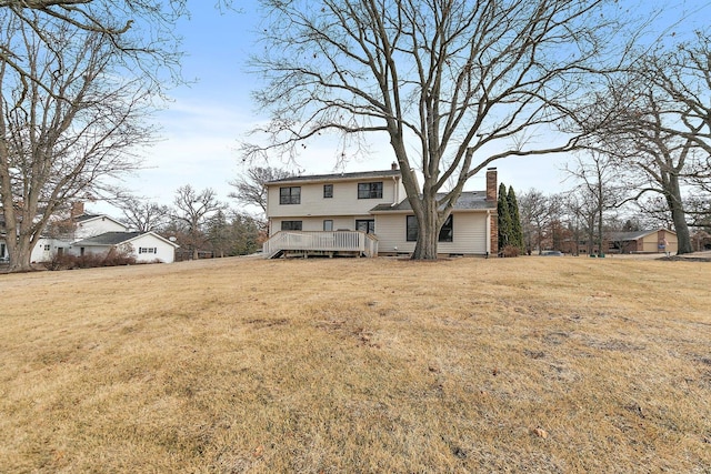 back of house featuring a wooden deck and a lawn