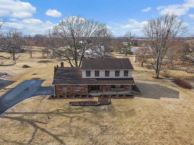 view of front of house with a porch and a front lawn