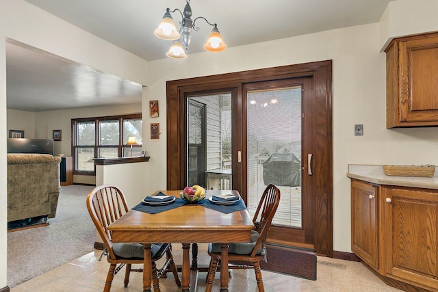 dining area with an inviting chandelier