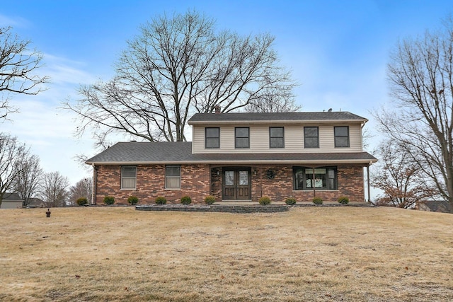 front facade featuring covered porch and a front yard