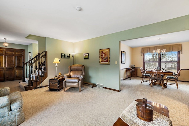 living room featuring a chandelier and carpet floors