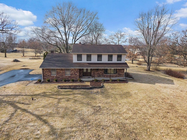 view of front of house with a porch and a front lawn