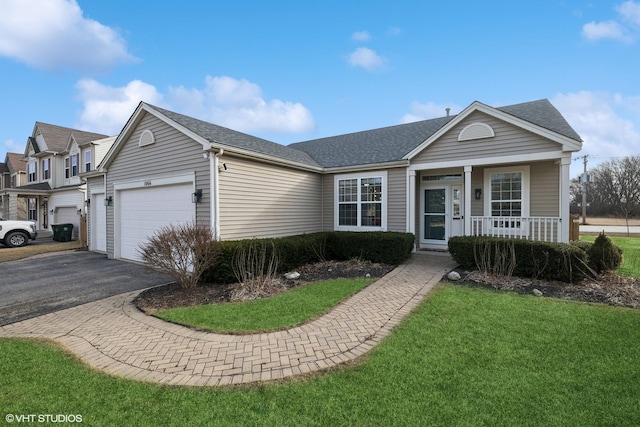 single story home with a porch, a garage, and a front lawn