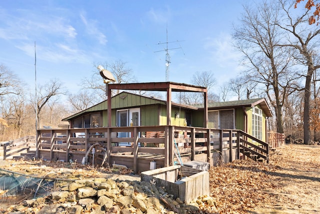 exterior space with roof with shingles and a wooden deck