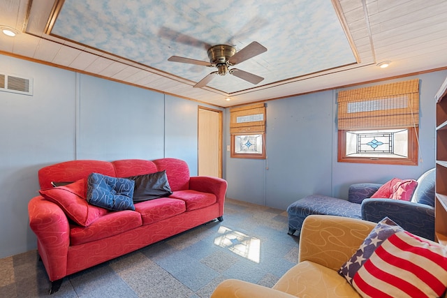 carpeted living room with a ceiling fan, recessed lighting, visible vents, and crown molding