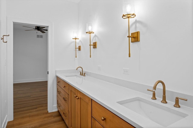 bathroom with vanity, hardwood / wood-style floors, and ceiling fan