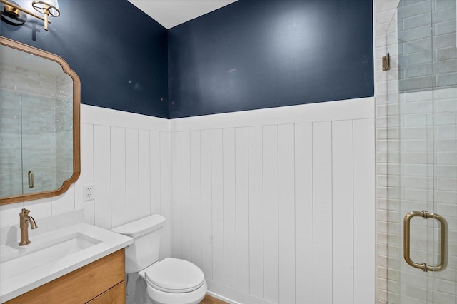 bathroom featuring walk in shower, vanity, and toilet