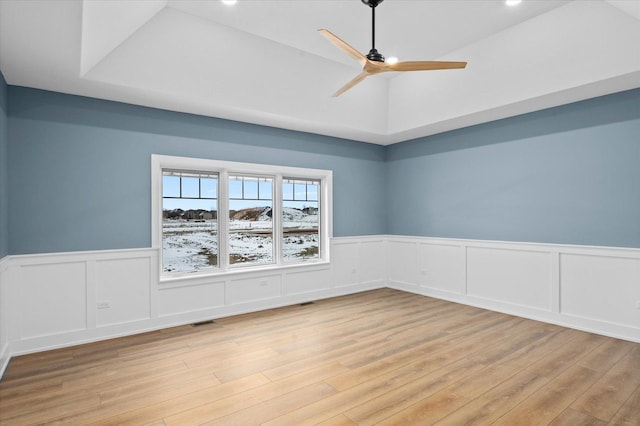 spare room with lofted ceiling, light hardwood / wood-style floors, and ceiling fan