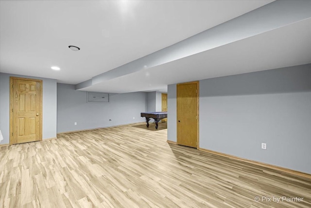 basement featuring pool table and light hardwood / wood-style flooring