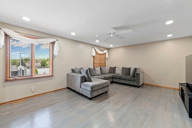 living room with hardwood / wood-style flooring and ceiling fan