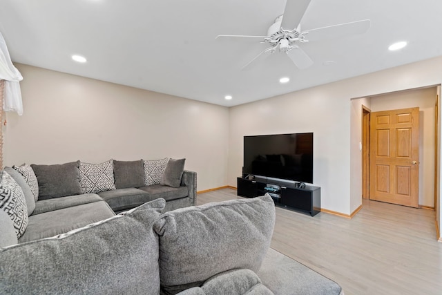 living room with light hardwood / wood-style flooring and ceiling fan