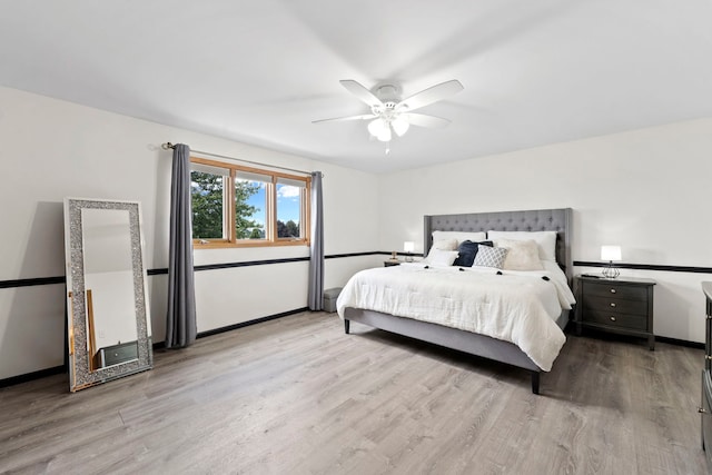 bedroom with ceiling fan and light wood-type flooring