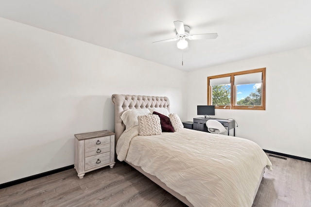 bedroom featuring hardwood / wood-style floors and ceiling fan