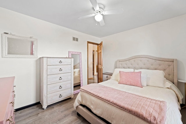 bedroom with wood-type flooring and ceiling fan