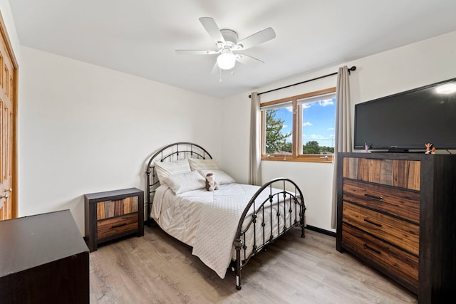 bedroom with ceiling fan and light hardwood / wood-style flooring