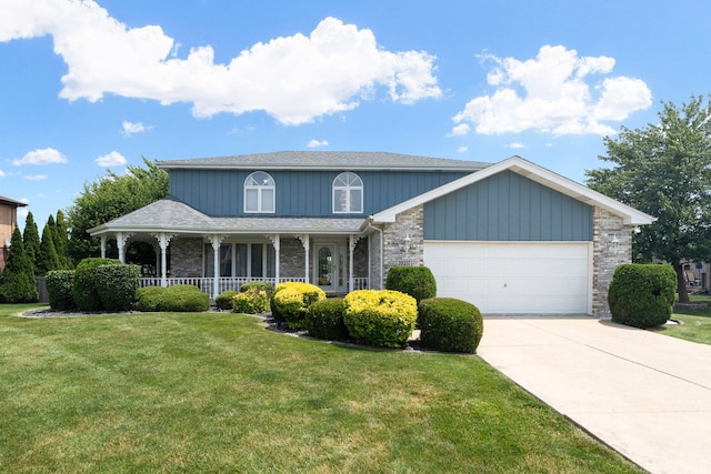 view of front of house with a porch, a garage, and a front yard