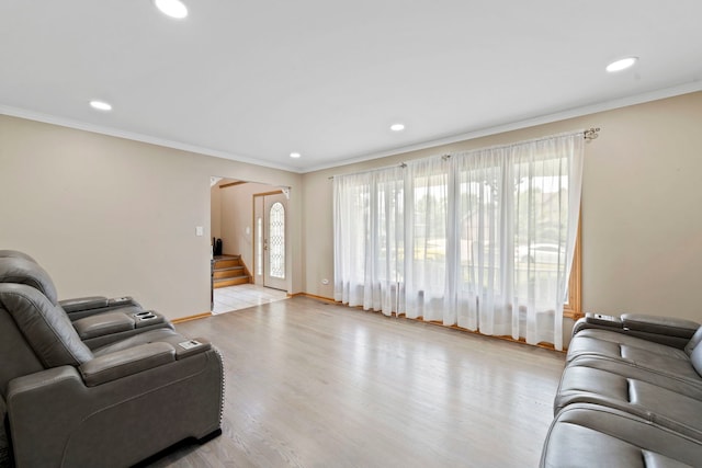 living room featuring ornamental molding and light wood-type flooring