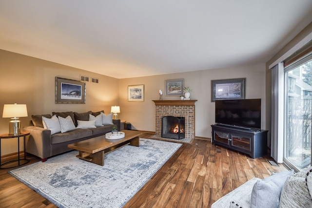 living room featuring hardwood / wood-style flooring and a fireplace