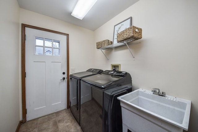 washroom with tile patterned flooring, sink, and washing machine and clothes dryer