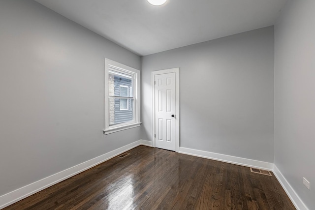 empty room with hardwood / wood-style floors