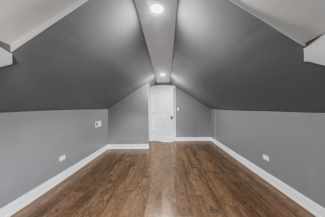 additional living space featuring hardwood / wood-style floors and vaulted ceiling