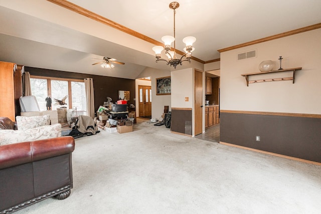 living area featuring visible vents, ornamental molding, vaulted ceiling, carpet floors, and ceiling fan with notable chandelier