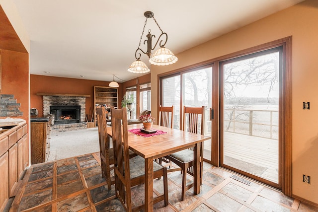 dining room featuring a fireplace and visible vents