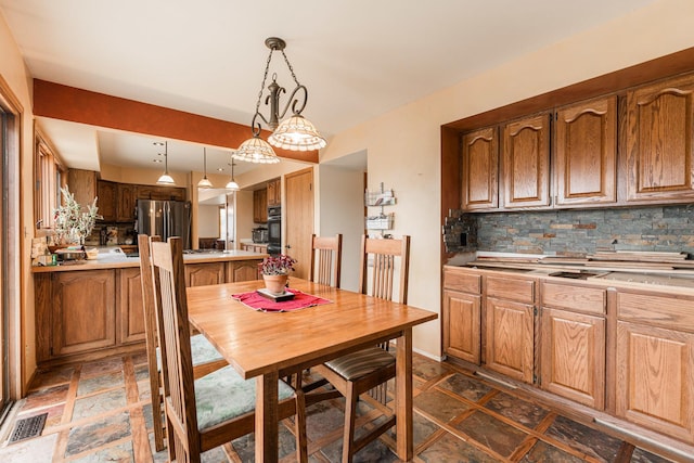 dining space with visible vents and stone tile floors