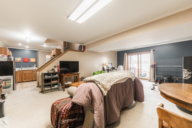 bedroom with access to exterior, freestanding refrigerator, and crown molding