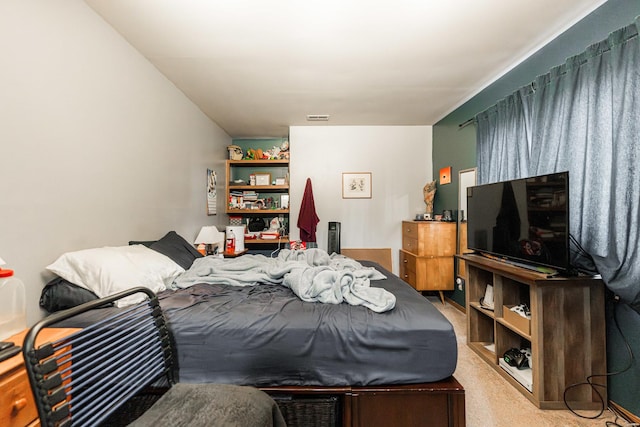 bedroom with visible vents and light colored carpet