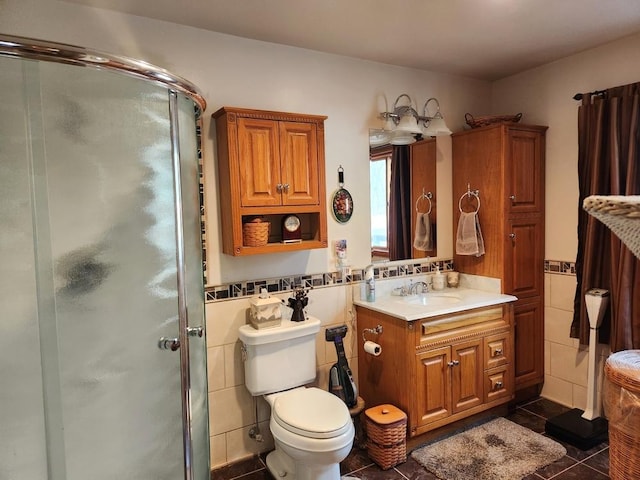 bathroom with walk in shower, toilet, tile walls, vanity, and tile patterned flooring