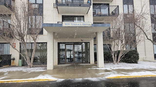 view of snow covered property entrance