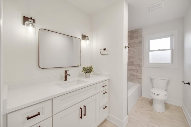 full bathroom featuring tiled shower / bath, vanity, and toilet