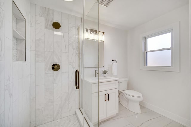 bathroom with vanity, toilet, and an enclosed shower