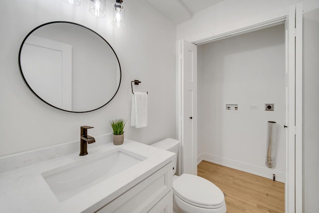 bathroom featuring vanity, toilet, and wood-type flooring