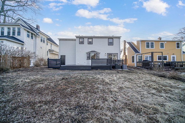 back of property with central air condition unit and a deck