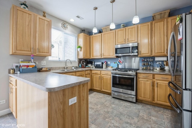 kitchen with sink, hanging light fixtures, light brown cabinets, kitchen peninsula, and stainless steel appliances