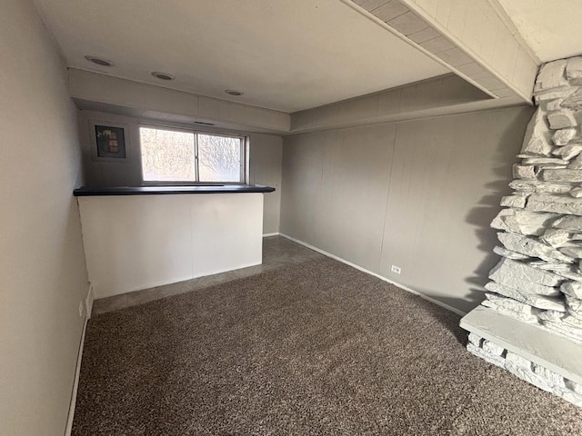 empty room with dark colored carpet