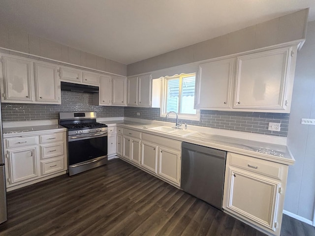 kitchen with dark hardwood / wood-style floors, white cabinetry, black dishwasher, sink, and stainless steel gas range oven